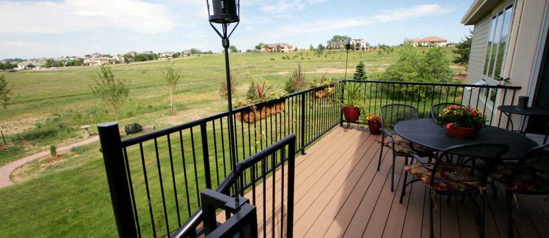 Exceptional sitting area outside with chairs and table that is built on Trex decking boards