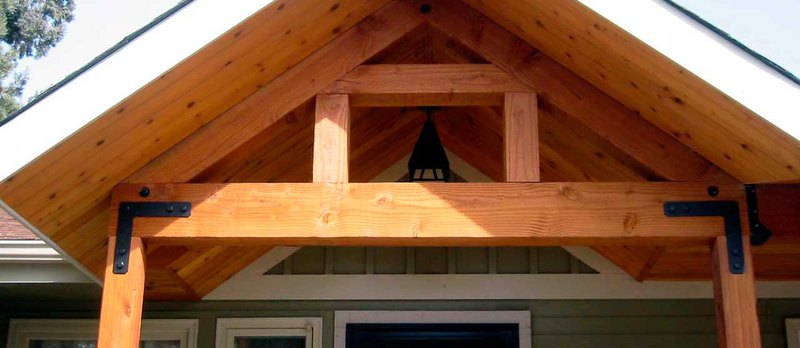 The front side of a house shows a timber supply used as insulating material under the roof.