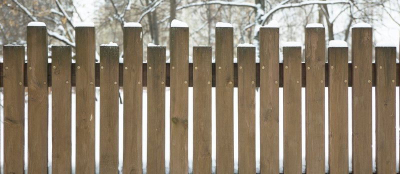 how to maintain wood fence during the cold winter months; a closeup of a fence